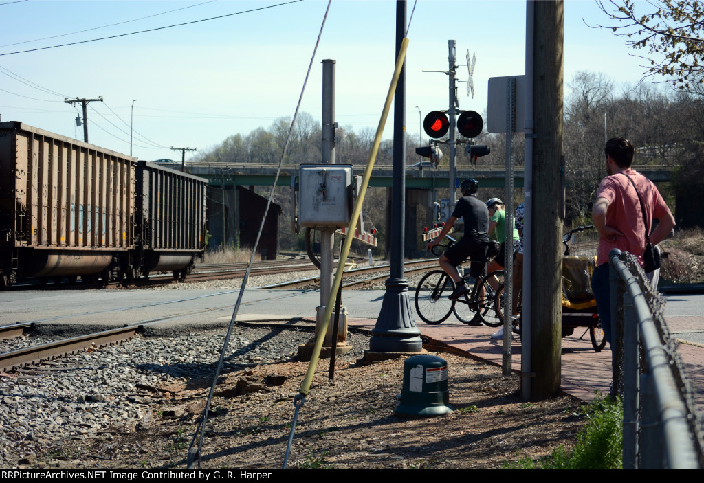 A few folks wait for the train of empties to clear Washington Street.  Lynchburg has a very good trail system due in large part to early railroad construction that commenced some 170 years ago.